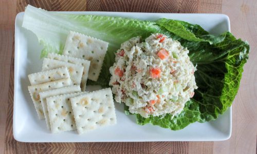 Crab salad served on lettuce with saltine crackers on the side.